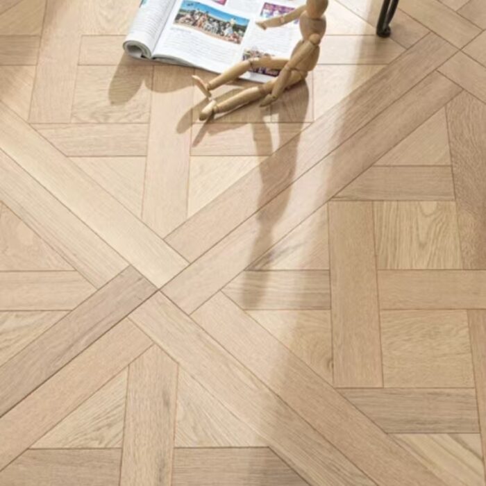 Solid oak Versailles flooring installed in interior space, showing geometric parquet panel layout and natural wood grain