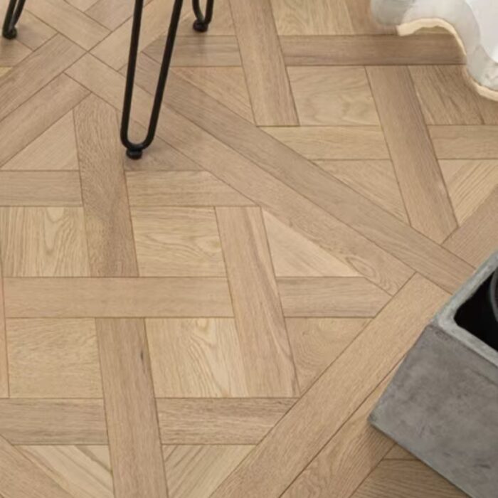Solid oak Versailles flooring installed in interior space, showing geometric parquet panel layout and natural wood grain