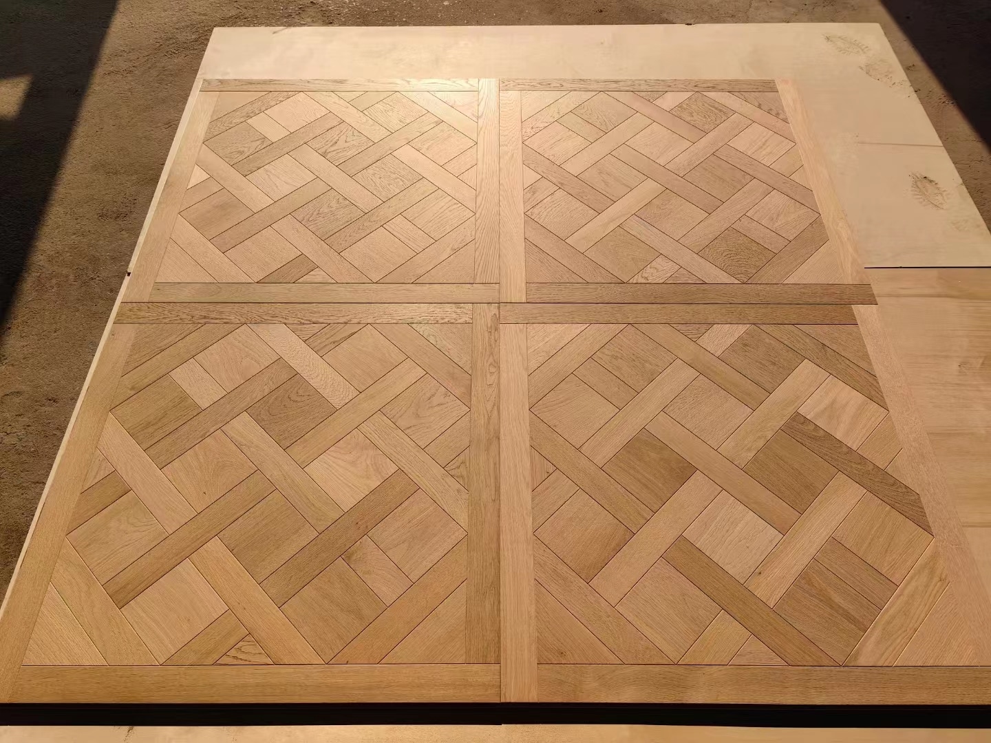 Solid oak Versailles parquet flooring featuring classic panel design, suitable for luxury residential and commercial interior projects.