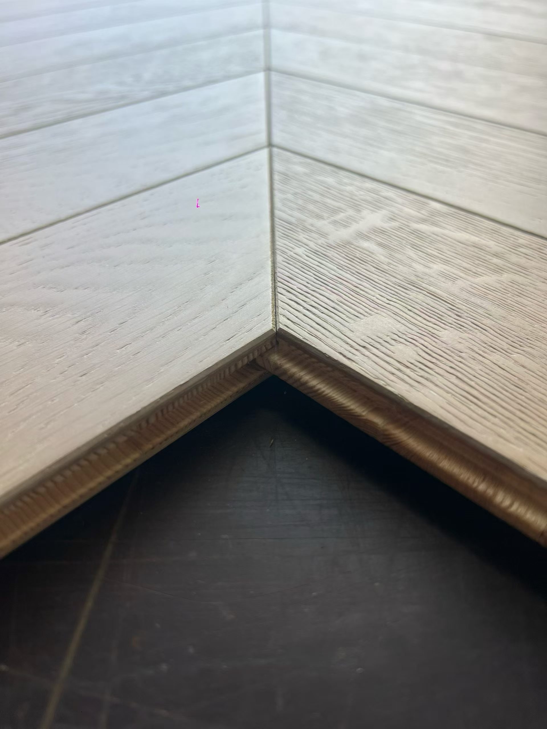 Brushed UV lacquered oak chevron flooring surface