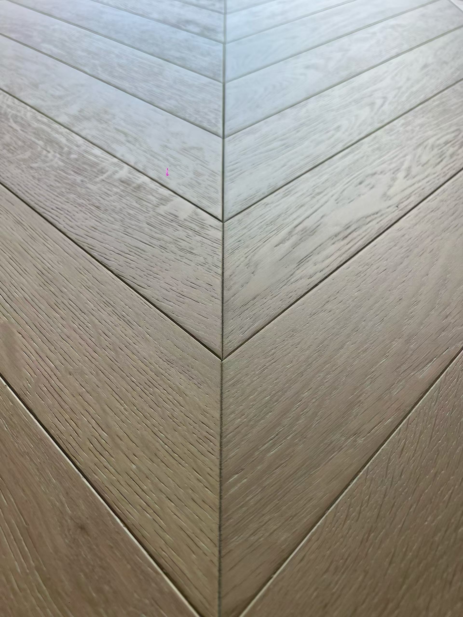 Brushed UV lacquered oak chevron flooring surface